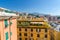 Colorful buildings on hill in city district of Genoa Genova and Monte Fasce mountain of Ligurian Appennines range