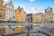 Colorful buildings reflecting in a puddle on Rynek square in Wroclaw