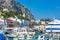 Colorful buildings, sightseeing boats, ferry with tourists in Marina Grande, Capri Island, Italy