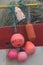 Colorful buoys hanging from fishing boat