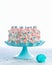 Colorful buttercream birthday cake over a light background with copy space. Celebration cake ideas for kids party
