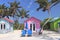 Colorful cabanas and lounge chairs on the beach in Princess Cays