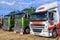 Colorful cabs of a row of big rig trucks