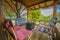 Colorful camping chairs and boxes stacked in the wooden gazebo