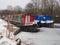 Colorful canal boats moored in the icy water, Kennet and Avon Canal