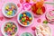 Colorful candies assortment on pink color background, top view