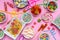 Colorful candies assortment on pink color background, top view