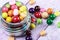 Colorful candies and lollipops in a jar on wooden