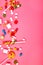 Colorful candies on pink background. Flat lay