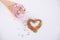 Colorful candies in the shape of a heart and ice cream cone on the white background. Place for lettering. Top view, flat lay