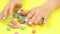 Colorful candies and woman manicured hands.