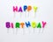 Colorful candles in letters saying Happy Birthday.