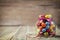 Colorful candy jar decorated with a bow against rustic wooden background