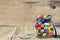 Colorful candy jar decorated with a bow against rustic wooden background