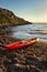 Colorful canoe next to the water on a beach
