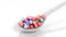 Colorful caplets inside a spoon