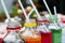 Colorful of carbonated soft drink pop soda bottles with plastic straw. Plastic bottles of assorted carbonated in variety of colors