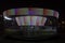 A colorful carousel spinning in the park with a long exposure time