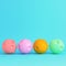 Colorful cartoon styled moons with craters on bright blue background in pastel colors. Minimalism concept