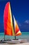 Colorful catamaran on the beach in the Caribbean with a blue sky