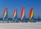 Colorful catamaran sailboats on a beach