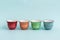 Colorful Ceramic Espresso Cups on Green Background