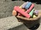 Colorful chalk sticks in the basket to draw art on concrete floor. Outdoor family activities, children learning skills, and talent