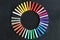 Colorful chalks lined up rounded on circle on blackboard background