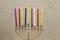 Colorful Chanukah candles lit in the menorah, candle light