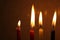 Colorful Chanukah candles lit in the menorah, candle light