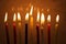 Colorful Chanukah candles lit in the menorah, candle light