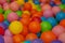 Colorful child balls. Multi-colored plastic balls. Achildren`s playroom. Background texture of multi-colored plastic balls on pla