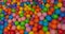 Colorful child balls. Multi-colored plastic balls. Achildren`s playroom. Background texture of multi-colored plastic balls on pla