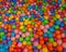 Colorful child balls. Multi-colored plastic balls. Achildren`s playroom. Background texture of multi-colored plastic balls on pla