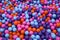 Colorful child balls. Multi-colored plastic balls. A children`s playroom. Background texture of multi-colored plastic balls on th