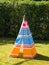 Colorful child`s toy Teepee tent on the grass
