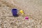 Colorful children\'s toys scattered on the sand at the beach