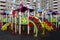 Colorful childrens playground with background of a big living block.