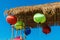 Colorful Chinese lanterns under the thatch roof under sunlight