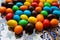 Colorful chocolate candies on the beautiful ornamental plate close up background