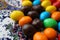 Colorful chocolate candies on the beautiful ornamental plate close up background