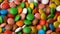 Colorful chocolate candy rotate background.