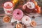 Colorful Christmas donuts and cookies on a wooden table in a rustic, cosy style.