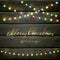 Colorful Christmas lights on black wooden background