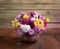 Colorful chrysanthemums bunch in old clay pot on rustic wooden table