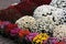 Colorful chrysanthemums in vases arranged on the sidewalk