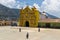 The colorful church of San Andres Xecul and three local Mayan woman walking on the street in Guatemala