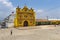 The colorful church of San Andres Xecul and three local Mayan woman walking on the street in Guatemala