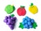 Colorful clay plasticine, delicious fruits, variety apples grapes blueberry dough, white background