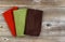 Colorful cleaning clothes on rustic wooden boards